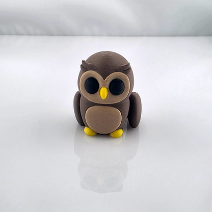 Brown mini flexy owl toy with yellow beak and feet on white background.