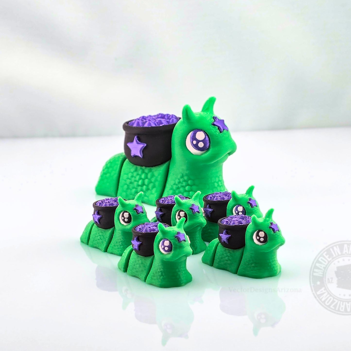 Large green cauldron snail surrounded by smaller matching spooky snails on white background.