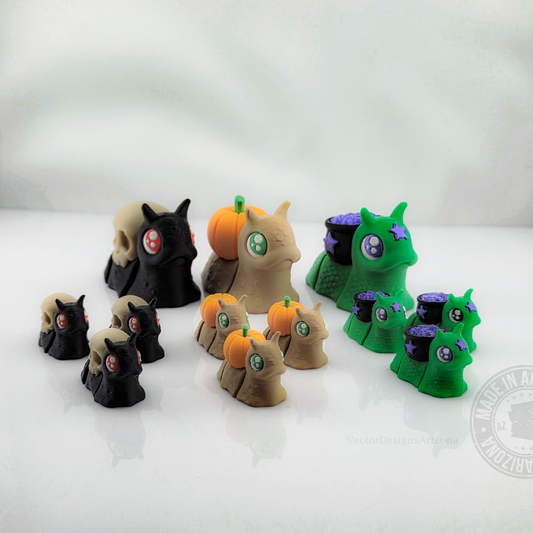 Assorted spooky snail figurines with skull, pumpkin, and cauldron shells on white background.