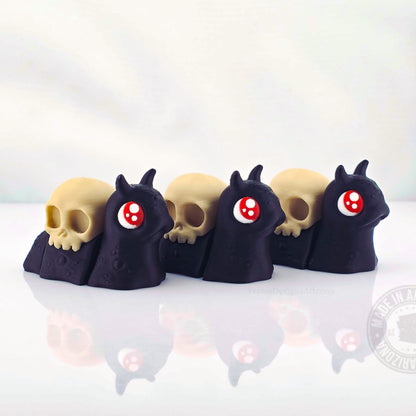Row of spooky black snails with skull shells on white reflective background.