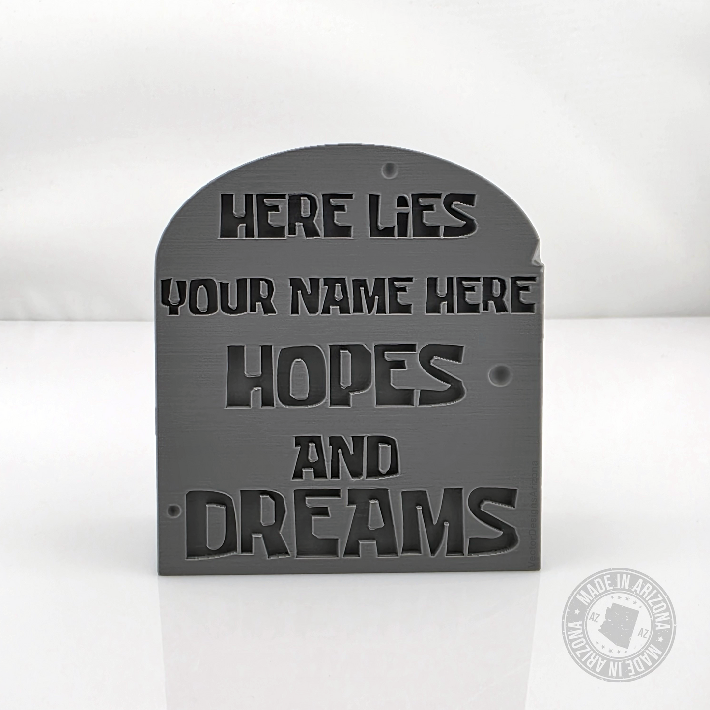 Gray tombstone desk sign with customizable here lies your name here engraving.